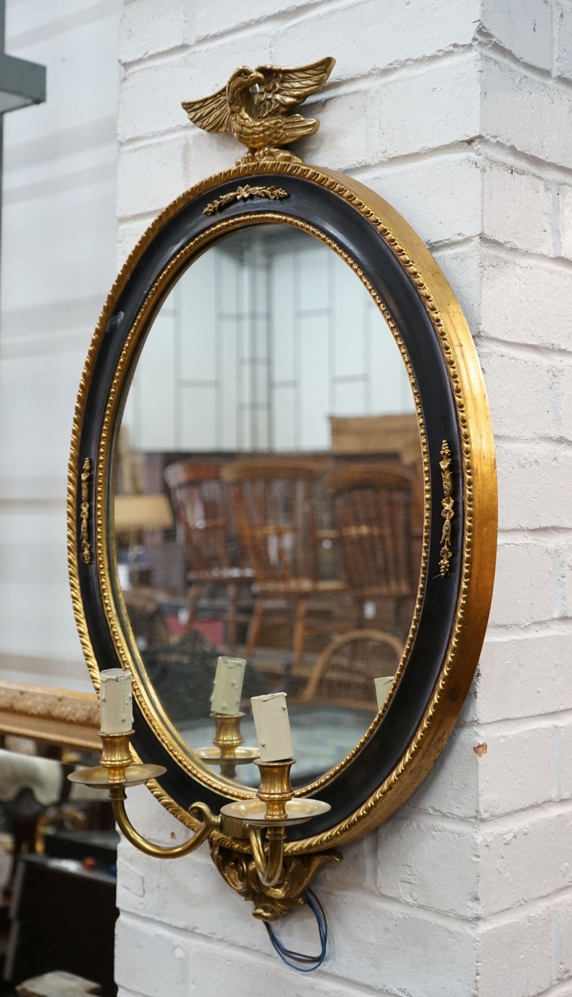 A pair of reproduction oval parcelgilt electric girandole wall mirrors, height 74cm